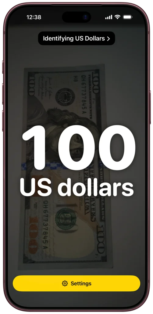 On an iPhone, NoteTell is identifying a one-hundred-dollar bill. The screen shows a large 100 and the words US dollars.